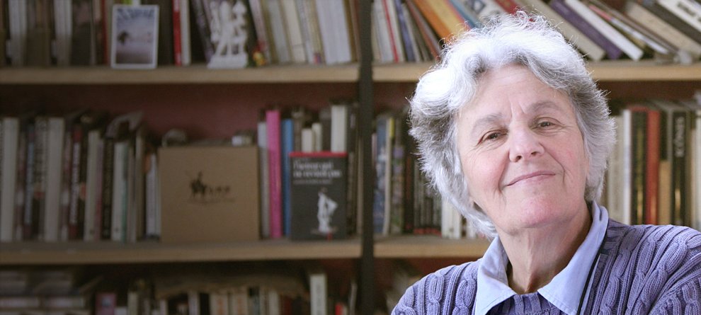 Portrait of a woman in front of a shelf of books